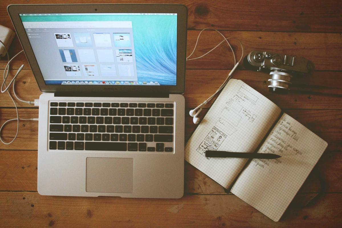 Desk with financial documents and laptop, representing expansion budget review work